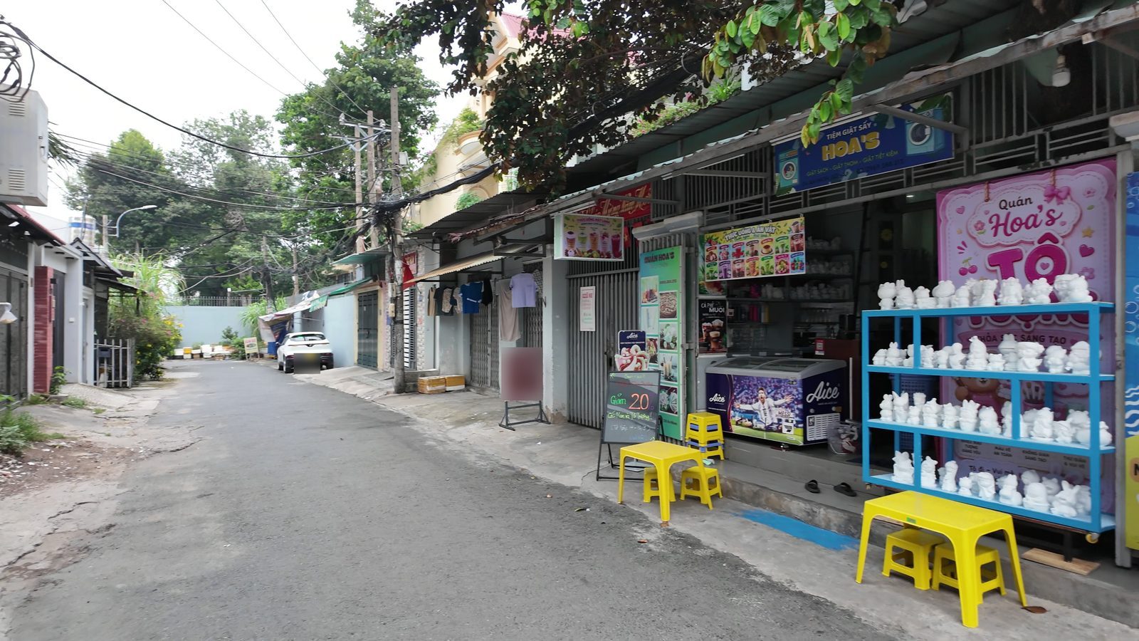 Dãy quán ăn và cửa hàng dọc con đường gần tòa nhà