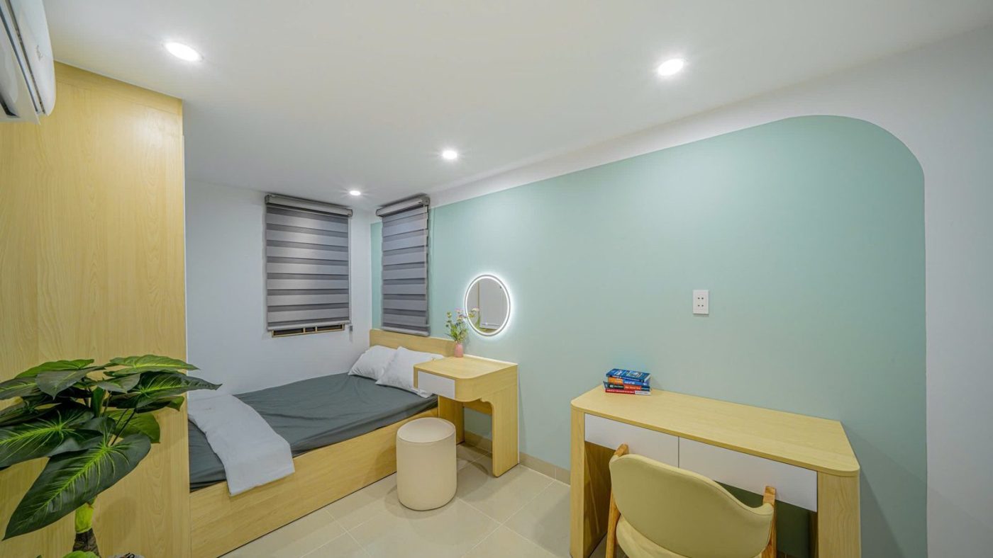Phòng cho thuê tường xanh nhạt có giường, bàn học và cây xanh, ảnh bìa bài viết về chủ nhà hạ giá chào